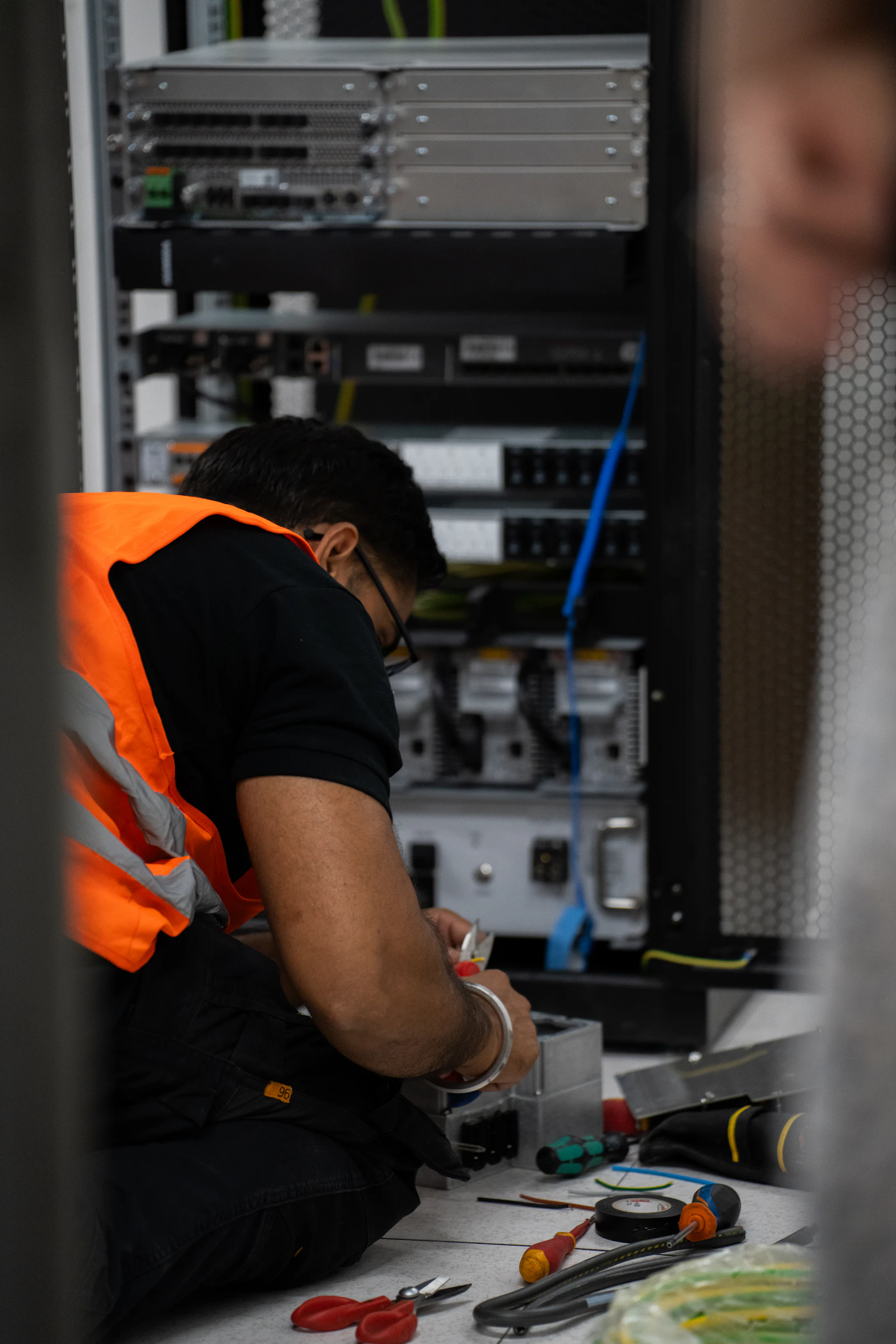 A technician carrying out maintenance on server equipment