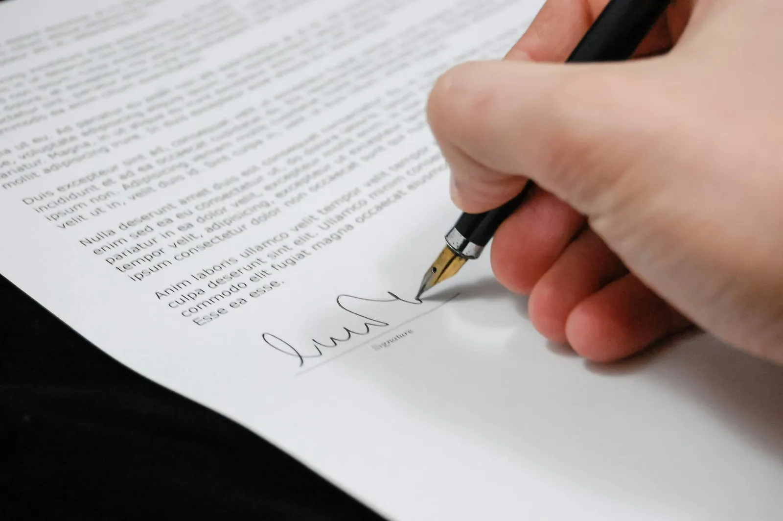 Close-up of a client signing a professional services document