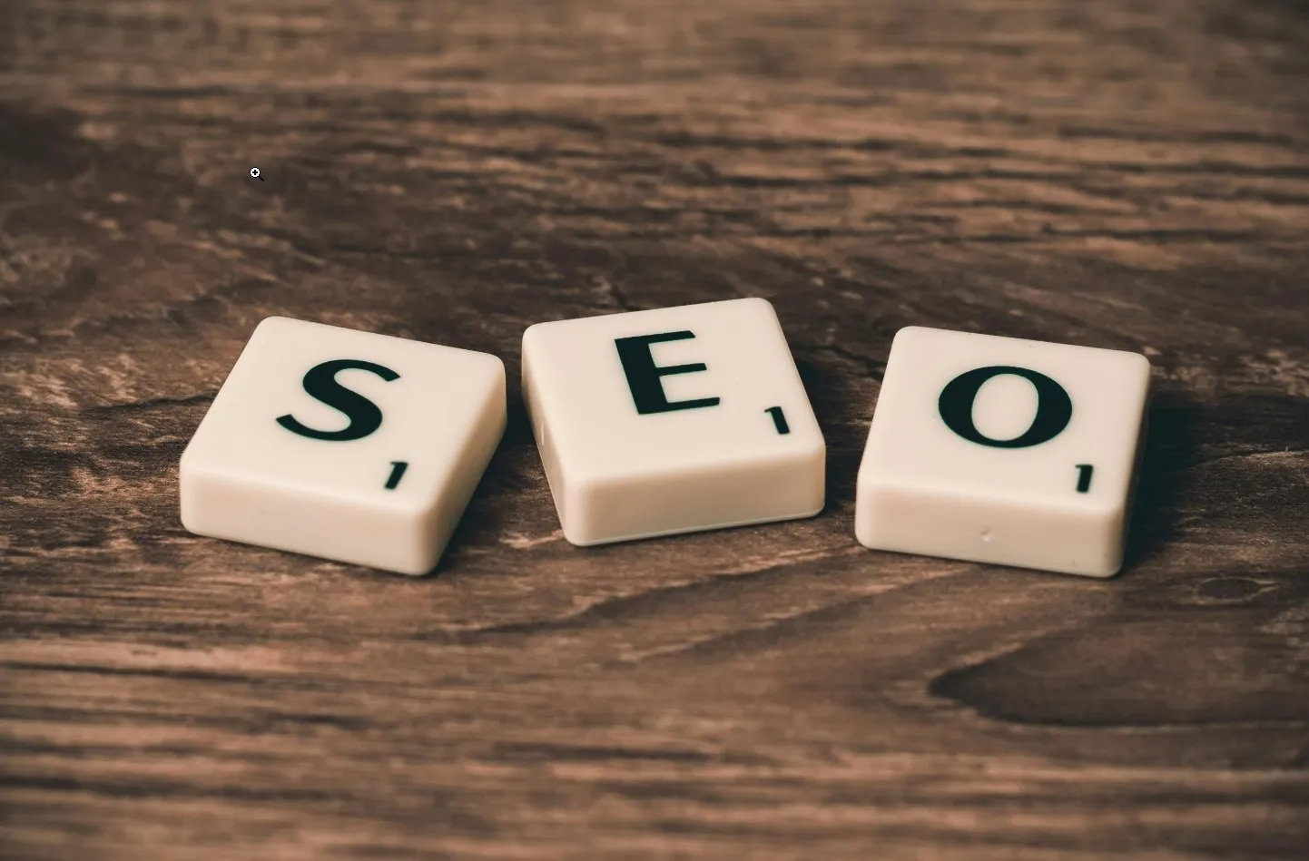 Wooden letter tiles spelling SEO on a table